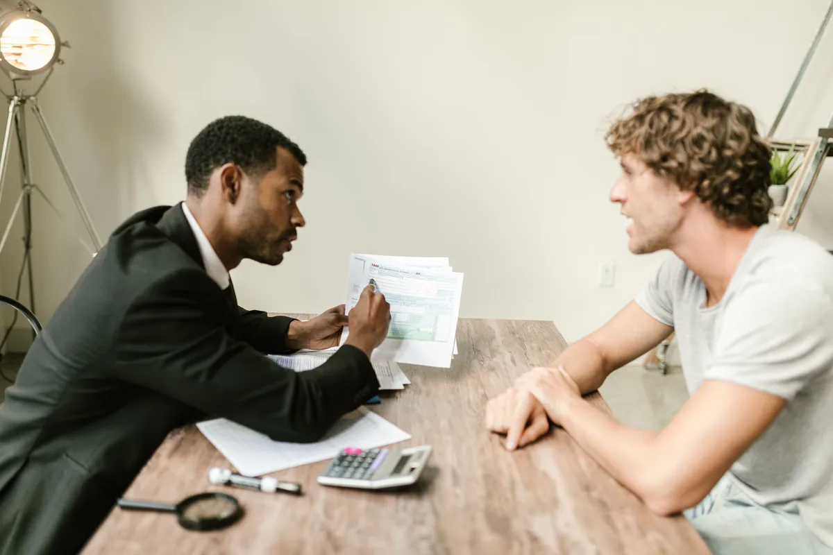 An adviser going through an Italian company filing calendar with a client