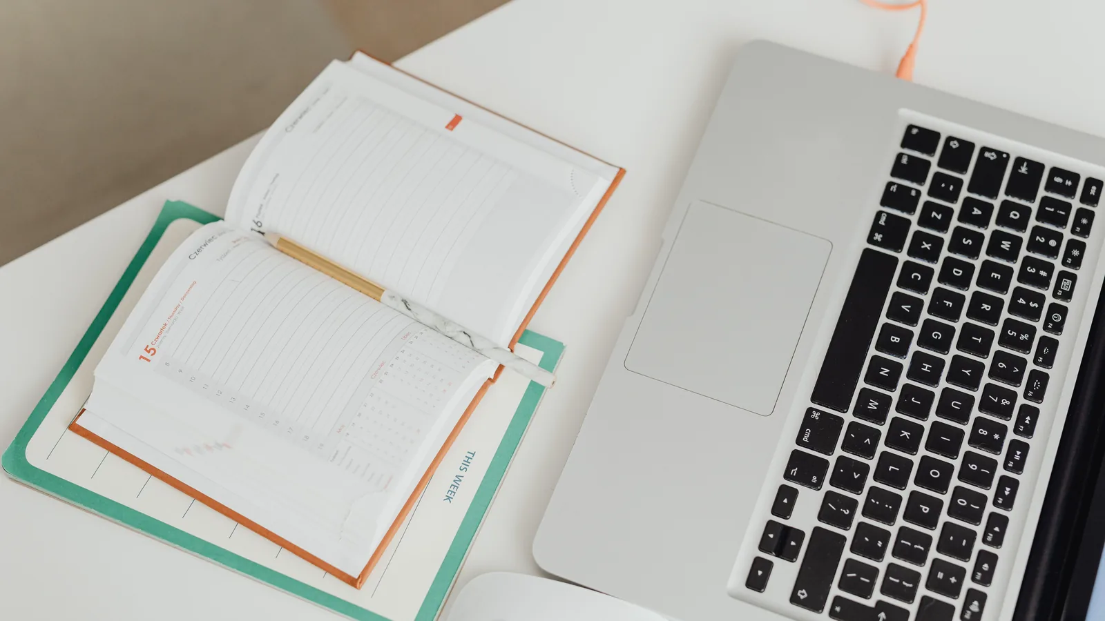 Printed accounting records and a laptop on the desk of an Italian bookkeeping practice