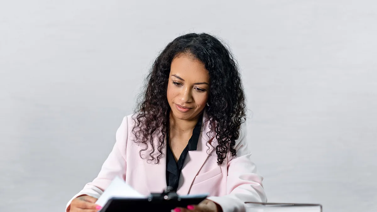 Adviser reviewing customer due diligence and beneficial-ownership documents for an Italian business account application