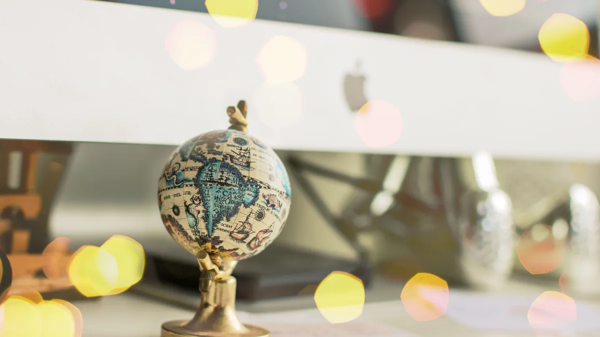 A world globe on an office desk, representing a dual-resident company's conflict between two tax jurisdictions
