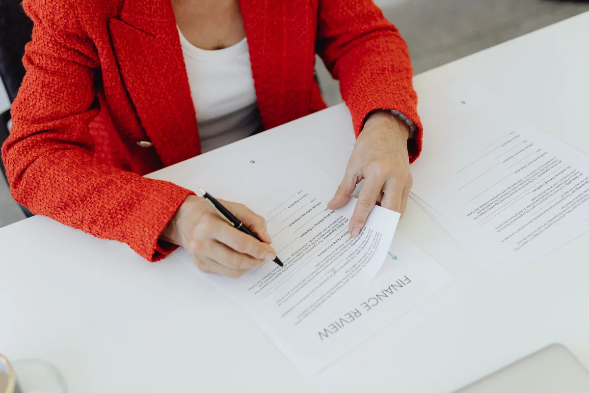 A document being signed at an office desk