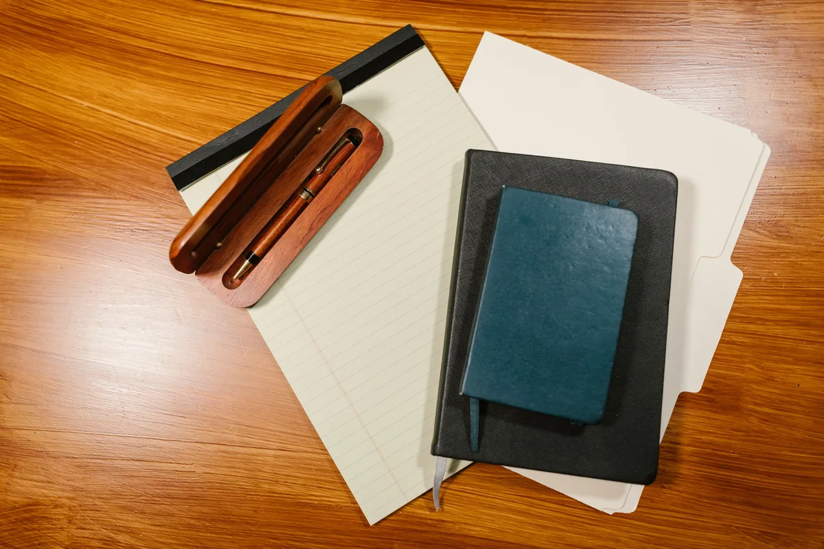 A document folder and a pen on a desk