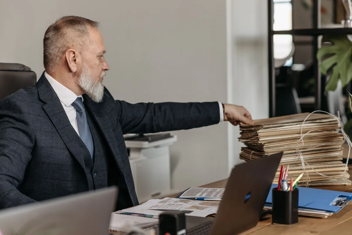 Corporate files stacked on an office desk