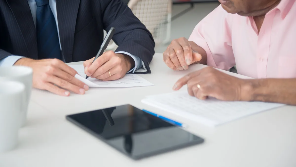 An adviser discussing representative office compliance with a client
