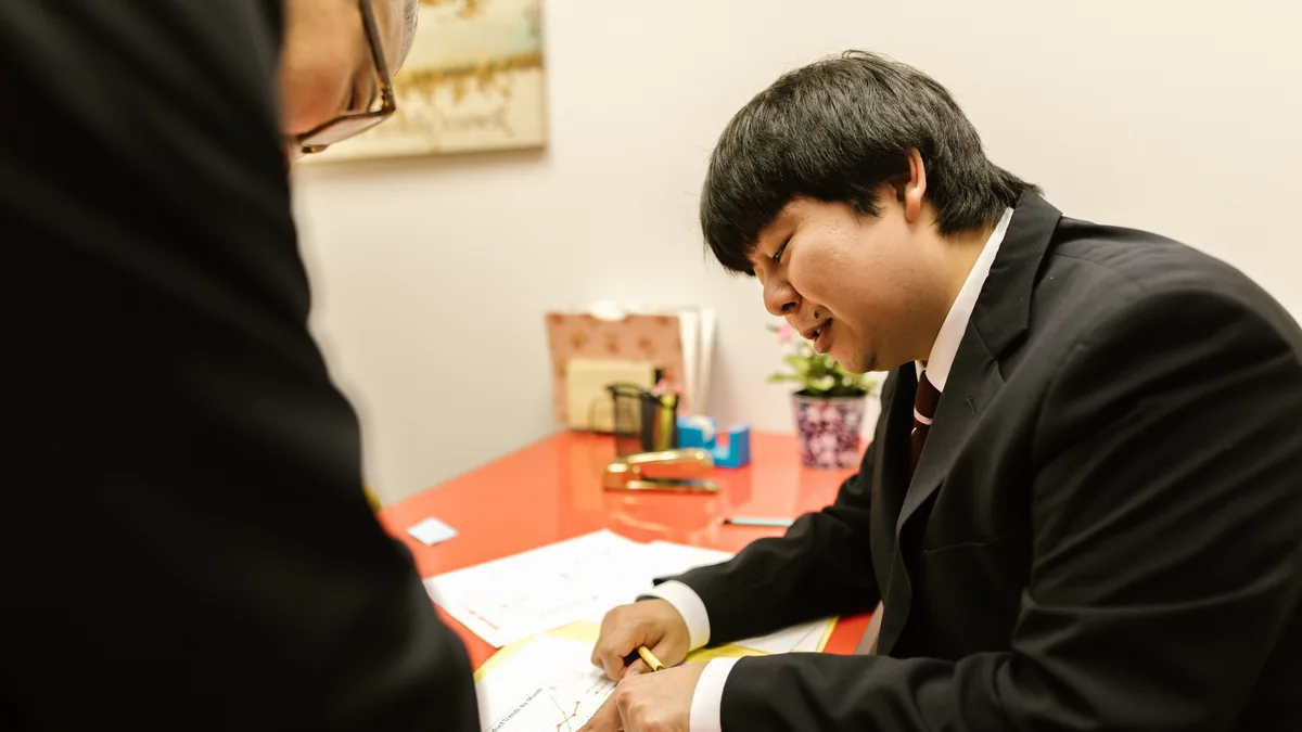 Two professionals reviewing tax documents at a meeting table
